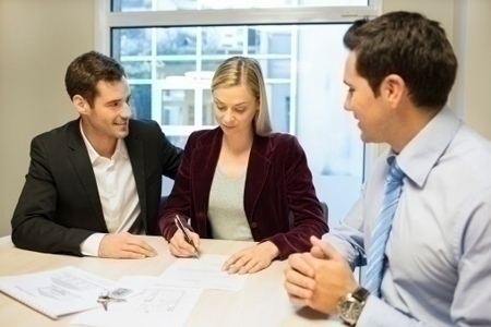 pending_home_sale_couple_signing