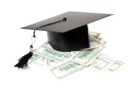 Paid education. Graduate cap on a pile of money