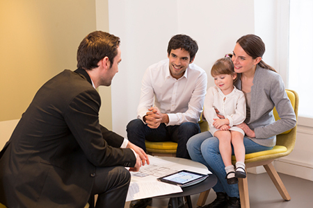 Young Family meeting real-estate agent to buy property