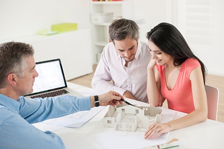 Young couple meeting construction planner