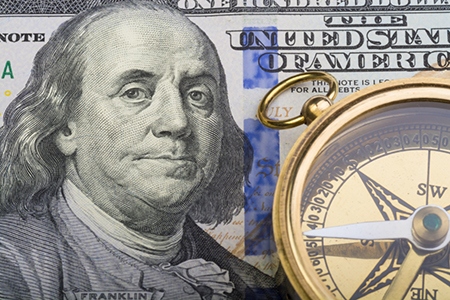 One Hundred Dollar Bill and Gold Compass