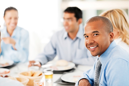 Four businesspeople having lunch in a restaurant.