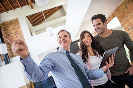 Real estate agent showing house to a couple