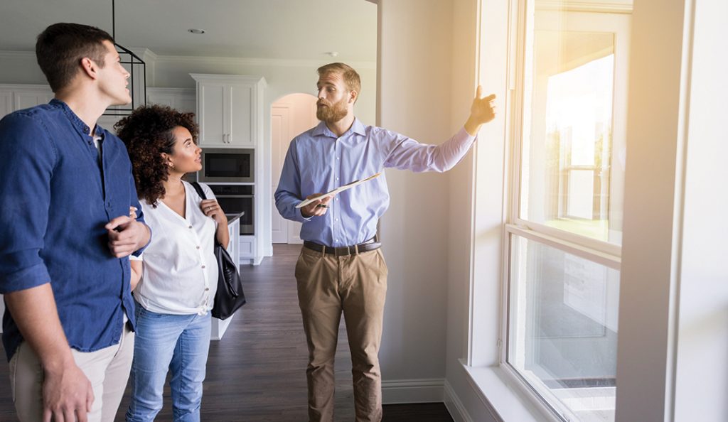 Male real estate agent shows new home — RISMedia