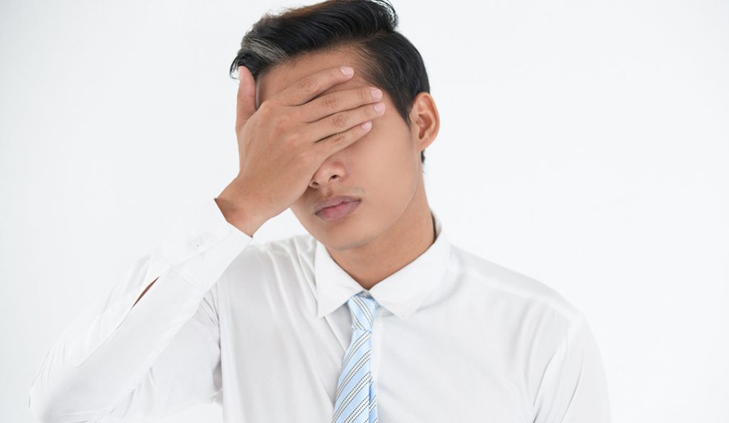 Face of worried young businessman making mistake — RISMedia