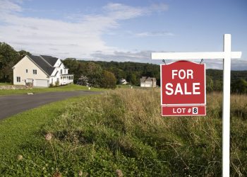 Real Estate sign showing land is for sale in a new subdivision.