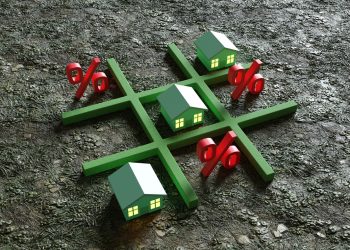 Green toy houses and red percentage signs replacing the noughts and crosses of the classic Tic Tac Toe game. Illustration of the concept of the challenge of high interest rate to mortgage loans