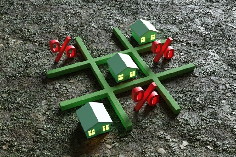Green toy houses and red percentage signs replacing the noughts and crosses of the classic Tic Tac Toe game. Illustration of the concept of the challenge of high interest rate to mortgage loans