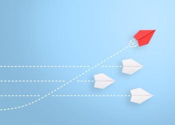 Group of paper plane in one direction and with one individual pointing in the different way, can be used leadership/individuality concepts. New idea, change, trend, courage, creative solution, innovation and unique way concept.