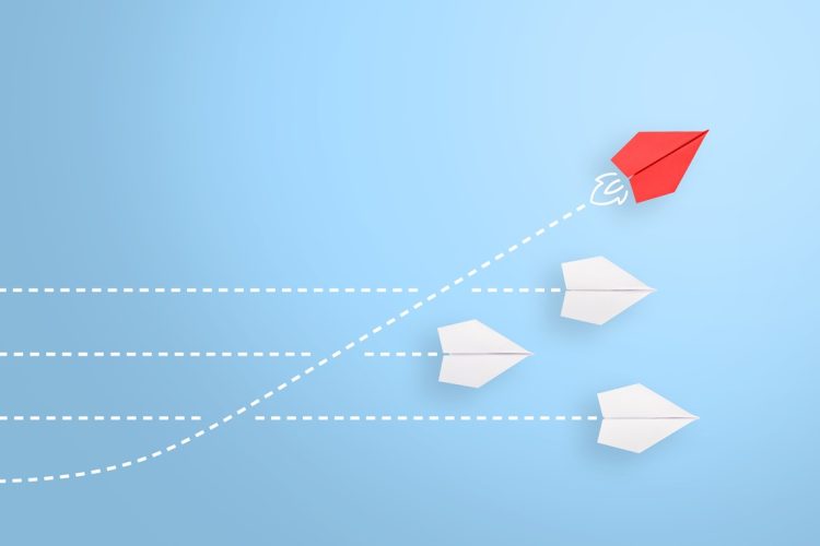 Group of paper plane in one direction and with one individual pointing in the different way, can be used leadership/individuality concepts. New idea, change, trend, courage, creative solution, innovation and unique way concept.